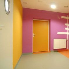 an empty room with pink and yellow walls