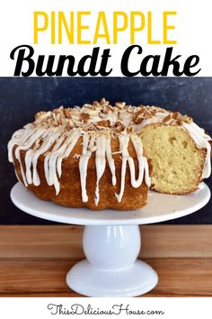 a pineapple bundt cake with white icing and nuts on top sitting on a pedestal