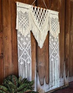 a white wall hanging on the side of a wooden door