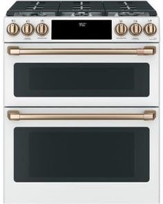 two white and gold ovens side by side