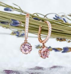 Whimsical yet elegant, Hanaka features a pair of blush-pink Rosé sapphires cut in the shape of an open blossom and framed by petals of glistening moissanites. In the drop style, the blooms dangle delicately from studded huggie hoops, adding a touch of elegance to the delightful spirit of spring. Made to order. Please allow 6-8 weeks for delivery. DETAILS: Gemstone: Type: Sapphire (cultured) Size: 6 mm (each) Color: Rosé Pink Cut: Blossom Design: Style: Drop Accents: Round Brilliant Moissanites B Luxury Pink Diamond Earrings Brilliant Cut, Luxury Pink Brilliant Cut Diamond Earrings, Luxury Pink Earrings With Brilliant Cut, Elegant Pink Sapphire Jewelry With Halo Design, Pink Diamond Earrings With Diamond Accents As Gift, Elegant Pink Sapphire Halo Jewelry, Pink Diamond Earrings As Gift, Pink Diamond Earrings Gift, Pink Diamond Earrings For A Gift