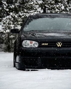 a black car is parked in the snow