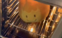 an orange is sitting in the oven and it's light shining on its side