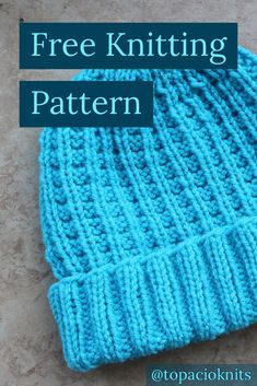 a blue knitted beanie with the text free knitting pattern on top of it