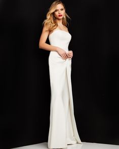 Dance the night away in this crepe strapless jumpsuit by Jovani 03828. Crafted from luxurious crepe fabric, this jumpsuit features a strapless neckline that exudes timeless glamour. The wide leg design offers a flattering fit that elongates the legs, perfect for formal events or a chic evening out. The closed back style ensures a sleek and streamlined appearance, while the floor-length silhouette adds a touch of drama. This ensemble is both simple and sexy, making it a versatile addition to your One Piece Pant Suit, Fashion Bella, Evening Jumpsuit, Coctail Dresses, Bridal Jumpsuit, Dresses Quinceanera, Unique Prom Dresses, Strapless Neckline, Strapless Jumpsuit