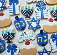 decorated cookies with hanukkah symbols and candles are displayed on a white surface