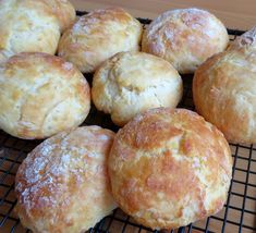 a bunch of biscuits sitting on top of a cooling rack