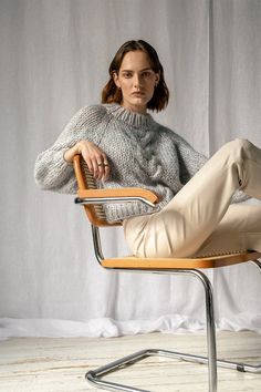 "The Chunky Braid Sweater -- a chunky yet lightweight raglan sweater featuring a braid cable stitch and an extra chunky ribbed neck. Hand knit with warm, super soft and luxurious kid mohair that feels like being wrapped inside a squishy, puffy cloud. Designed to flatter all silhouettes with its wide boxy fit, slightly cropped body and wrist-exposing voluminous balloon sleeves. Made to order in 6 colorways -- 2 solid colors and 4 with a subtle melange feel. Handcrafted in Greece. DETAILS * Super soft, premium quality Italian mohair * Composition: 60% kid mohair, 40% microfiber * Hand wash in cold water SIZE & FIT * Voluminous ribbed mock neck * Wide boxy fit, slightly cropped body and sleeves * Raglan balloon sleeves * Extra chunky ribbed trims * Models are 172cm (5'6\") and 174cm (5'8\"), Oversized Cable Knit Sweater, Lightweight Open Front Cardigan, Chunky Braids, Crochet Clutch Bags, Slouchy Cardigan, Raglan Sweater, Blue Jumper, Raglan Pullover, Bleu Pastel