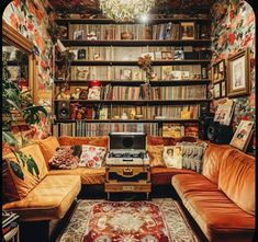 a living room filled with lots of furniture and bookshelves covered in pictures on the walls