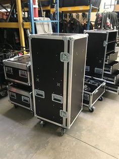 two large black cases sitting on top of each other in a room filled with equipment