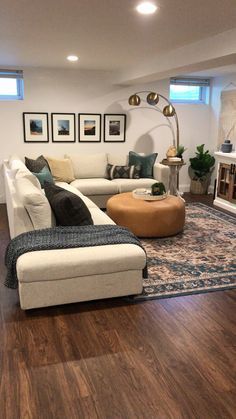 a living room with hardwood floors and white furniture