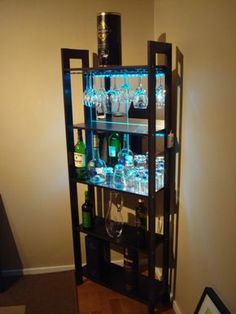 a shelf filled with lots of bottles and glasses