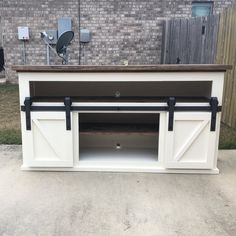 an outdoor entertainment center with sliding doors