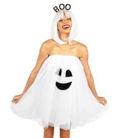 a woman wearing a white dress with a ghost face on it