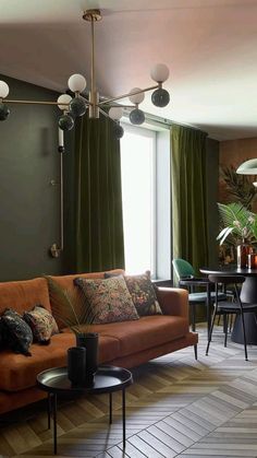 a living room filled with furniture and green curtains