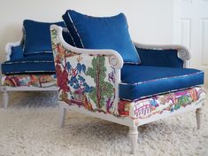 a chair with blue cushions sitting on top of a white carpeted floor next to a wall