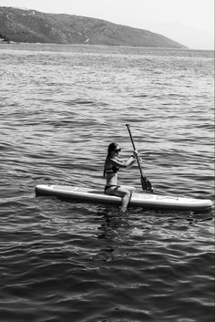 a woman is paddling her kayak in the water