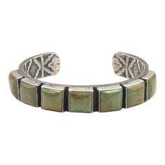 This is part of Chairish’s Costume Jewelry assortment.  Vintage Native American Navajo Sterling Silver Green Turquoise Cuff Bracelet by Kirk Smith (1956-2012)  This beautiful Southwest sterling silver cuff bracelet is set with seven square turquoise cabochons in smooth bezel settings. The bracelet design is simple except for a fantastic arrow head pattern stamped on the underside of the cuff. The bracelet is signed on the underside Kirk Smith sterling and is beautifully decorated with an intrica Statement Cuff Bracelet, Pattern Stamping, Arrow Head, Turquoise Bracelet Cuff, Bracelet Design, Turquoise Cuff, Sterling Silver Cuff Bracelet, Galveston, Sterling Silver Cuff