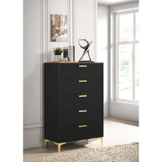 a black and gold chest of drawers in front of a white wall with a window