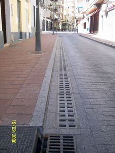 a city street with a drain in the middle