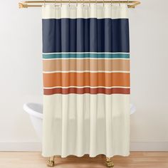 a shower curtain with an orange, blue and brown striped design on it's side