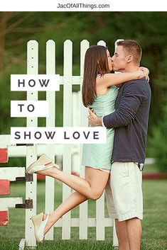 a man and woman kissing in front of a white picket fence with the words how to show love