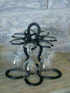 four wine glasses sitting on top of each other in front of a stone wall,