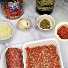 the ingredients are laid out on the counter to make this meatloaf recipe, including onions, peppers, and seasonings