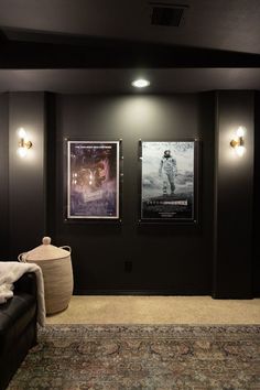 an empty room with two movie posters on the wall