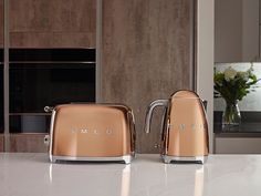 two toasters sitting on top of a kitchen counter