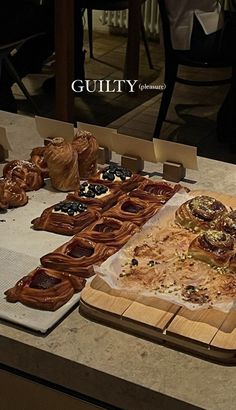 an assortment of baked goods are displayed on a counter top with the caption guilt