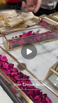 pink flowers are placed in gold frames on a table with the words your dream invest