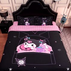 a bed with black and pink comforters on it