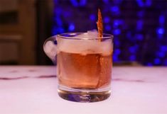 a close up of a drink in a glass on a table