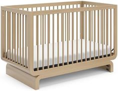 a wooden crib with white sheets on the bottom and side rails, in front of a white background