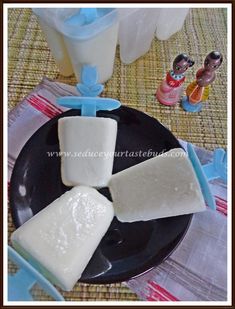 three pieces of cheese sitting on top of a black plate