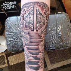 a person with a tattoo on their arm has a stairway in the sky and clouds