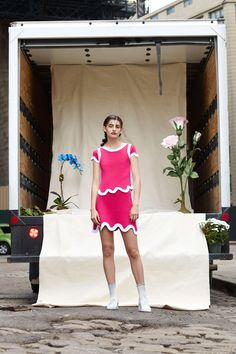 a woman standing in front of a white box truck