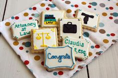 decorated cookies on a polka dot cloth with the names of different states and country symbols