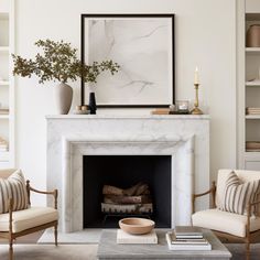 a living room filled with furniture and a fire place in front of a white fireplace