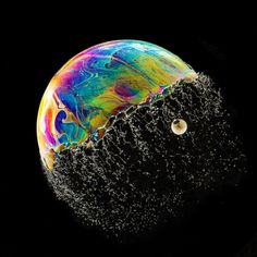 an image of water bubbles floating in the air and on top of a black background