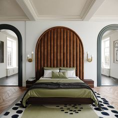 a large bed sitting in the middle of a bedroom next to two arched doorways