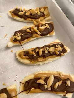 chocolate covered pretzels sitting on top of parchment paper