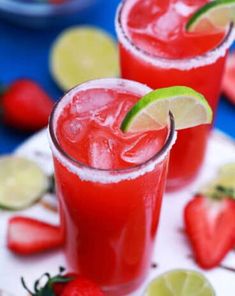 two glasses filled with strawberry margaritas and lime slices