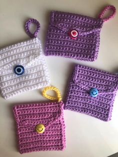 three crocheted purses sitting on top of a table