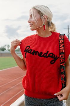 Gear up for game day with this red knit top featuring an embroidered "gameday" design in black. Show off your team spirit for the ULL Rajin' Cajuns with this sleeveless, stretchy top perfect for tailgates and football games. Get ready to cheer your team to victory in style! runs true to size with a roomie fit stretchy model, Kylee is wearing a size small Team Spirit Red Sleeveless Tops, Red Sleeveless College Tops, Red Sleeveless Tops For College, Collegiate Red Sleeveless Top, Red Collegiate Sleeveless Top, Red Tops For Game Day In Fall, Collegiate Sleeveless Tops For Game Day, Red Team Spirit Tops For Fall, Sports Fan Sleeveless Tops For Game Day