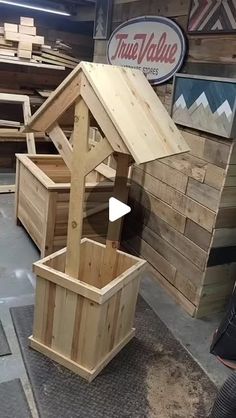 several wooden boxes are stacked on top of each other and one is holding a birdhouse