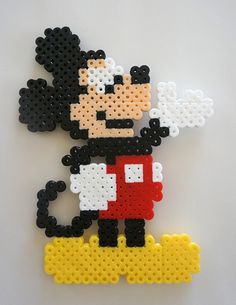 a piece of art made out of perler beads with an image of mickey mouse