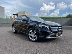 a black mercedes suv parked in a parking lot