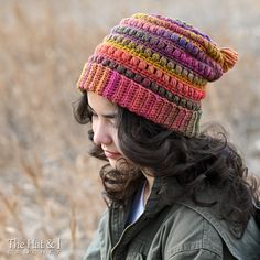 a woman wearing a multicolored knitted hat